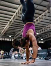 Load image into Gallery viewer, A great shot of a girl doing a handstand walk in our amazing ribbed cropped tank in the colour orchid flower. The tank is slightly cropped to give breathability during workouts.  The material is ribbed throughout and is extremely soft to touch.