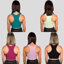 Load image into Gallery viewer, A photo collage of two girls wearing the 5 colours available in the DFNT. ribbed cropped tank - Black, Orchid Flower, Lime, Teal &amp; Lilac.  The tanks have a high neck and are naturally breathable.  The fabric is soft to the touch and stretchy. The logo placement is via a tag sewn into the left seam.