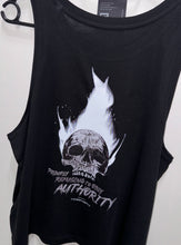 Load image into Gallery viewer, A photo showing the back of a female fit slightly cropped vest top.  The shirt has a big bold print on the back of a skull in flames. Underneath the skull is the defiant tag line &#39;Proudly Refusing To Obey Authority&#39; with The Defiant Co logo under that. The vest is black in colour.