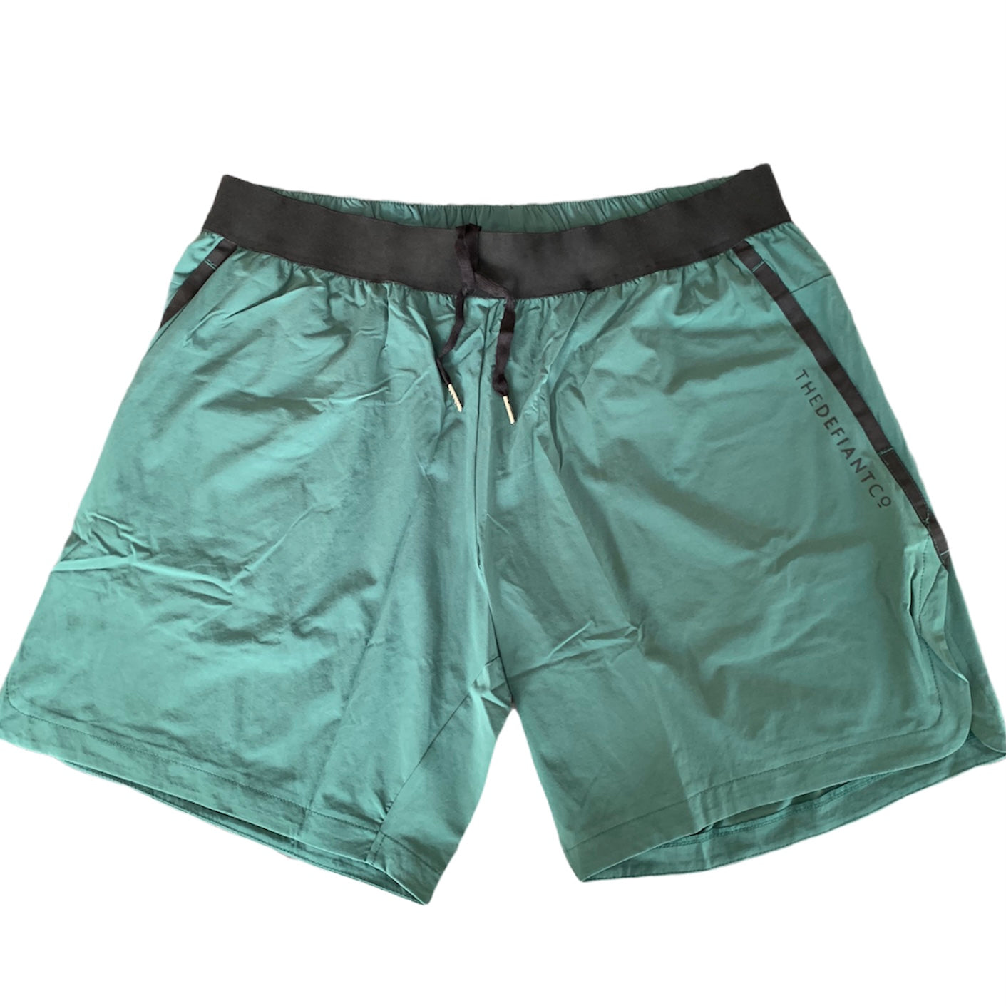 A photo of the best selling The Defiant Co Performance Shorts.  The shorts have a black elasticated waistband with draw strings and have The Defiant Co logo down the left leg.  The shorts have two pockets, one either side and are the colour racing green.