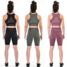 Load image into Gallery viewer, A photo collage showing a selection of female fit cycling style shorts from the back.  The shorts are designed to be tight against the skin and come in black, dark olive green and burgundy respectively.  There is a screen printed logo on the left leg reading DFNT. and there is a pocket suitable for mobile phones on the right leg.  There is also a screen printed logo on the back waistband that reads &#39;The Defiant Co&#39; in white. The shorts are just above knee high.