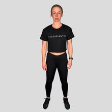 Load image into Gallery viewer, A girl wearing a cropped t-shirt .  The shirt is a female git and has a round neck and standard sleeve length.  The shirt has The Defiant Co logo across the centre of the chest.  The shirt is black in colour.