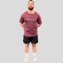 Load image into Gallery viewer, A photo showing the front of a slightly oversized Acid Wash unisex T-Shirt.  The shirt has the famous ‘The Defiant Co’ logo across the front of the chest.  The acid Wash effect of the shirt means no two are alike and provides the perfect blend of fashion and defiance. The shirt is burgundy with a slightly black wash.