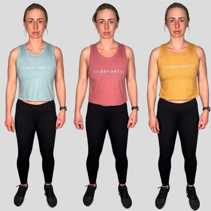A photo collage of all three variants of The Defiant Co cropped tank.  The colours include light blue, dusty pink and mustard.  The vests are a tight fit with a slightly cropped finish, they have thick straps and a high neckline.